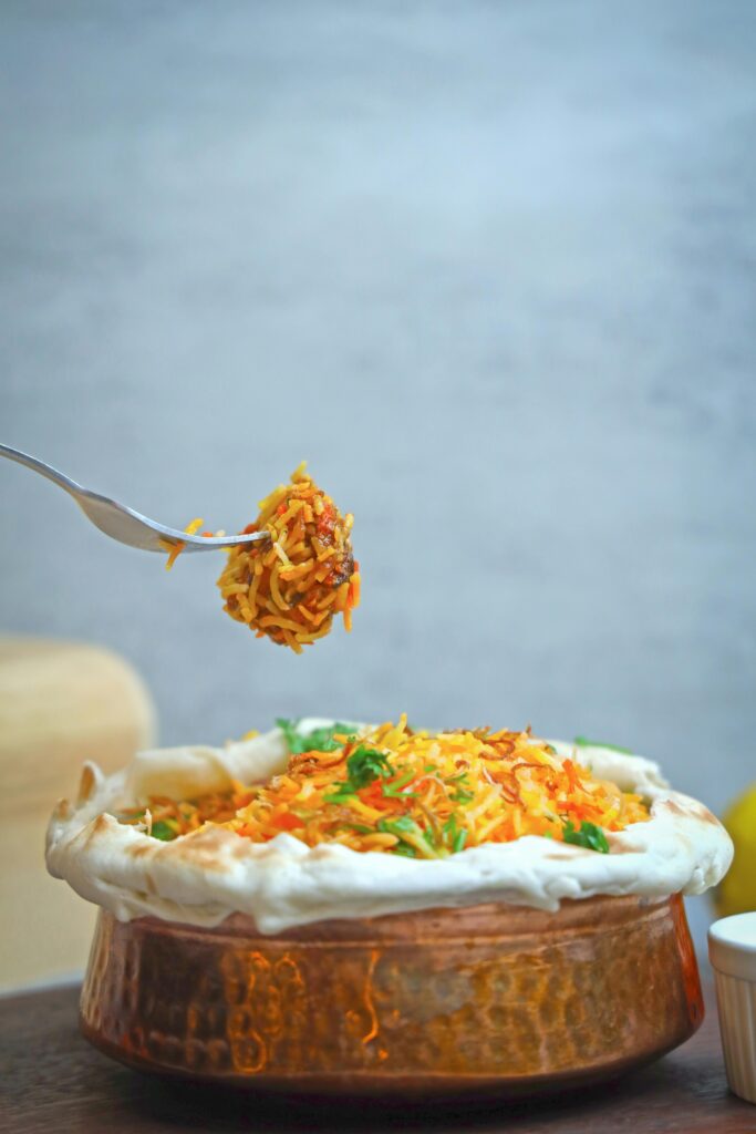 Delicious and aromatic chicken biryani in a traditional pot, perfect for food lovers.